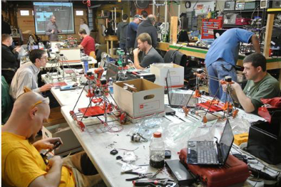 A group of men work on engineering projects in some of the existing buildings